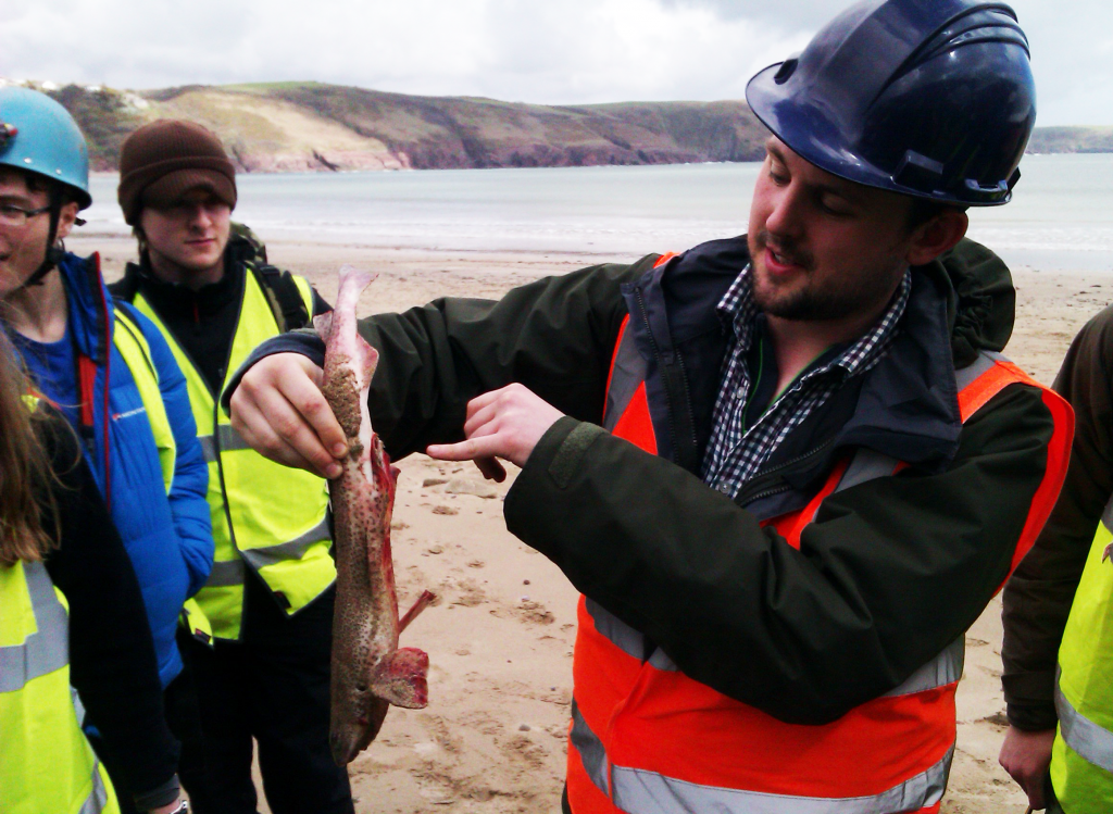 Tom with a dead shark showing disgusted students